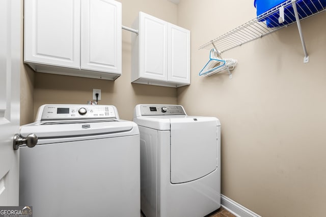 laundry room featuring cabinets and washer and dryer