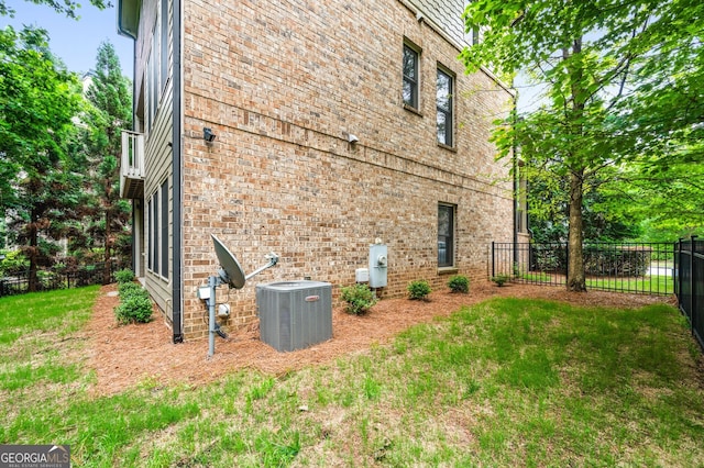 view of home's exterior with a lawn and central air condition unit