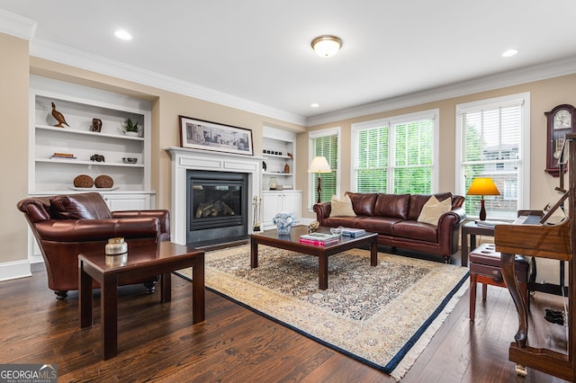 living room featuring built in features, crown molding, and dark hardwood / wood-style floors