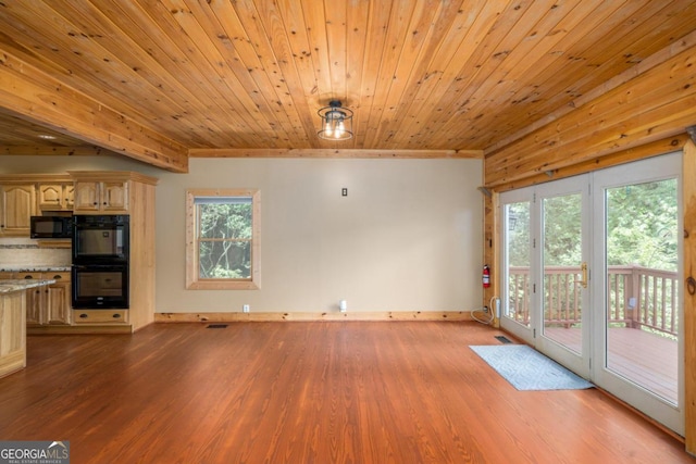 unfurnished living room with light hardwood / wood-style floors and wooden ceiling