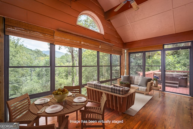 sunroom / solarium with ceiling fan, lofted ceiling, and a wealth of natural light