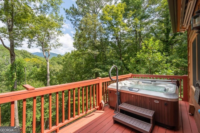 deck featuring a mountain view and a hot tub