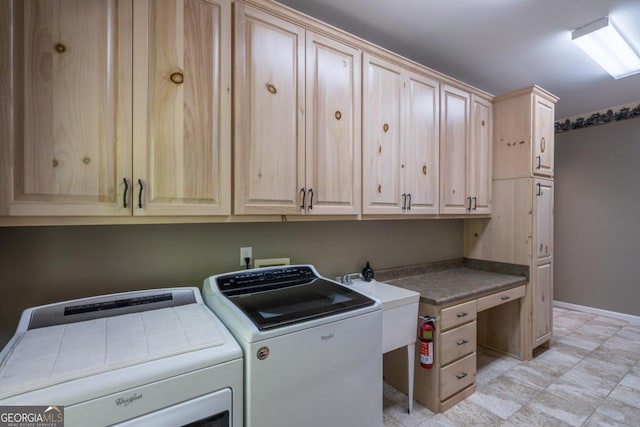 laundry room with cabinets, independent washer and dryer, and sink