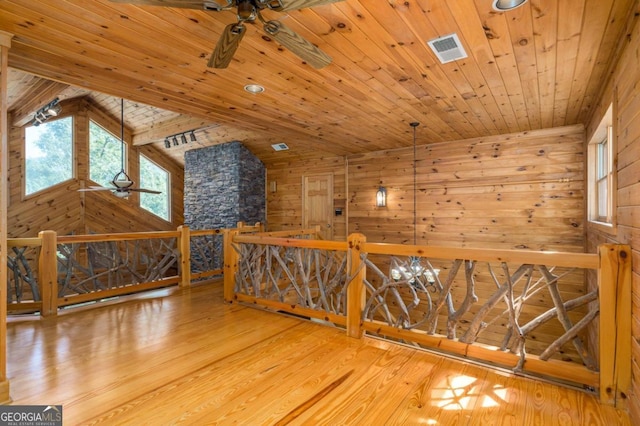 additional living space with hardwood / wood-style floors, wood walls, lofted ceiling, and wood ceiling