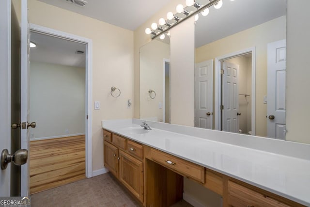 bathroom with hardwood / wood-style floors and vanity