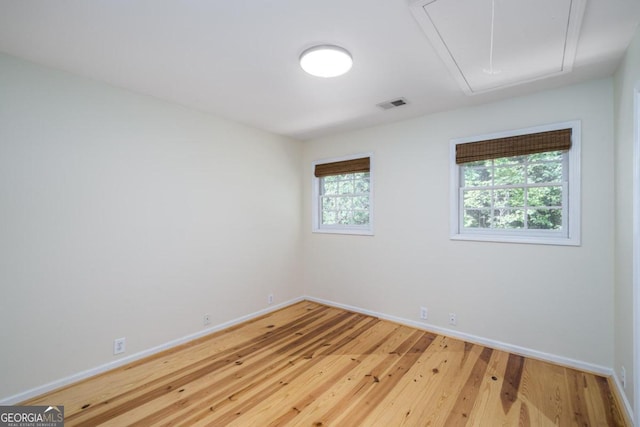 empty room with light hardwood / wood-style flooring