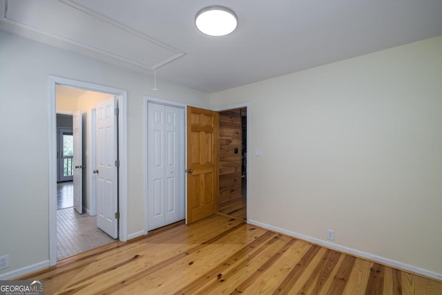 unfurnished bedroom featuring light hardwood / wood-style floors and a closet