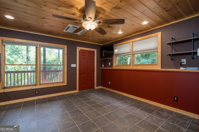 tiled spare room featuring ceiling fan and wood ceiling