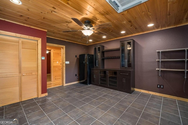 interior space featuring dark tile patterned floors, ceiling fan, and wooden ceiling