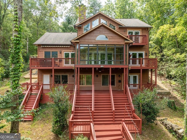 rear view of property with a sunroom