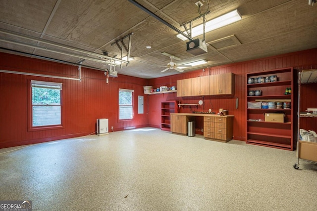 garage with electric panel, a garage door opener, and ceiling fan