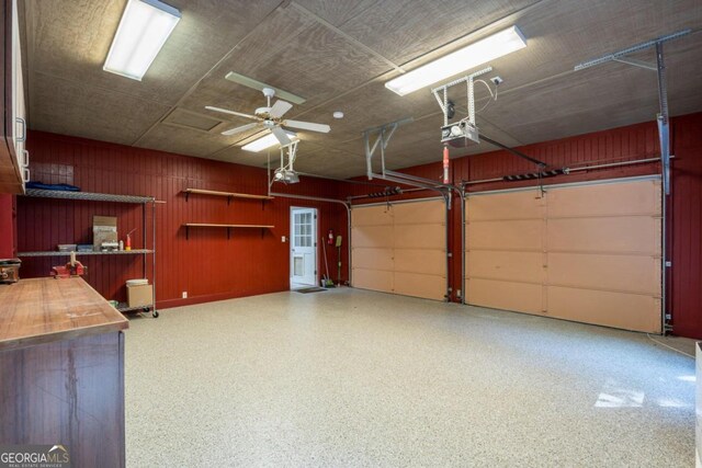 garage featuring a garage door opener and ceiling fan