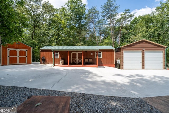 single story home with a garage and a shed