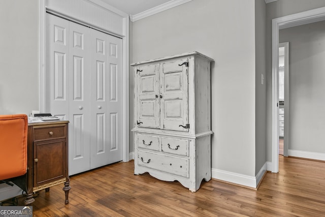 office featuring ornamental molding, light wood-type flooring, and baseboards