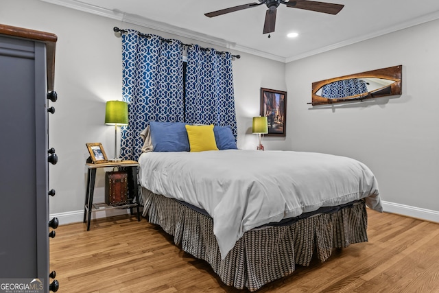 bedroom featuring recessed lighting, crown molding, baseboards, and wood finished floors