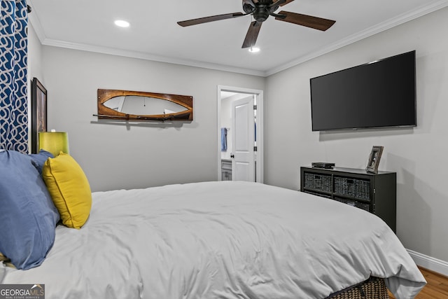 bedroom featuring ensuite bathroom, recessed lighting, wood finished floors, baseboards, and crown molding