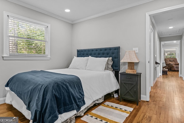 bedroom with ornamental molding, recessed lighting, wood-type flooring, and baseboards