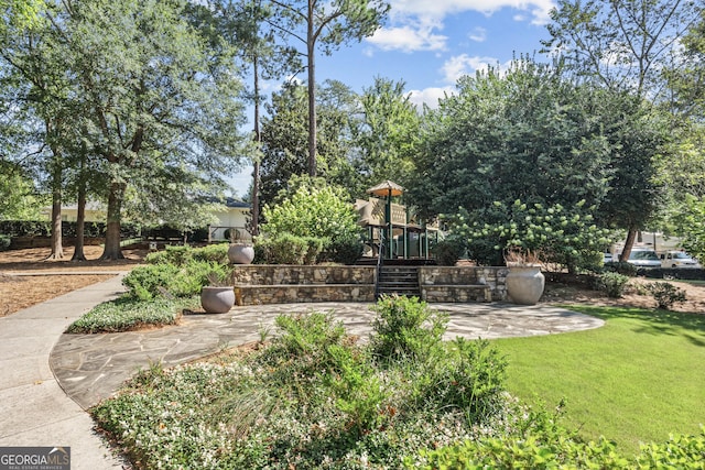 exterior space with playground community and a patio area