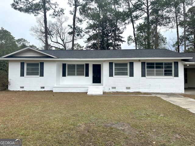 single story home featuring a front yard, brick siding, roof with shingles, and crawl space