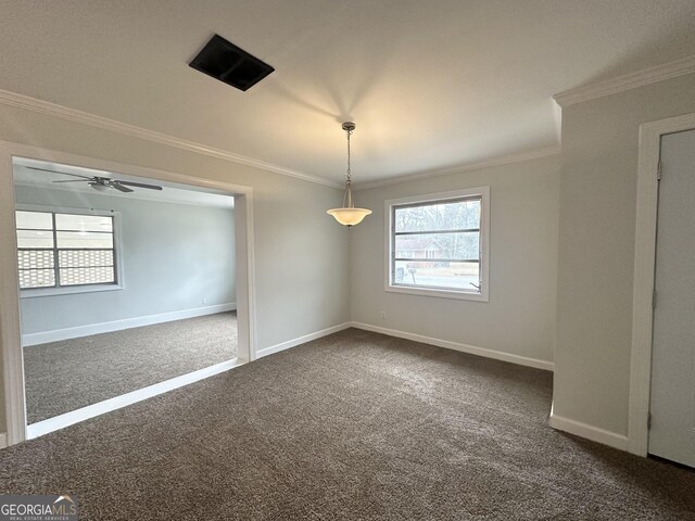 unfurnished room with a ceiling fan, baseboards, dark carpet, and ornamental molding