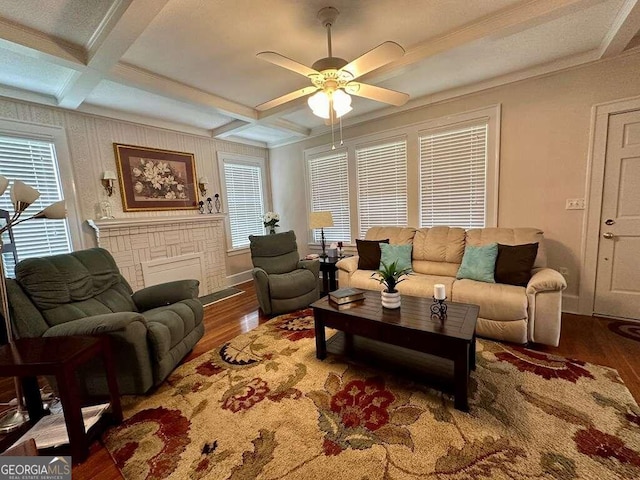 living area featuring coffered ceiling, plenty of natural light, and wood finished floors