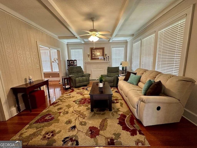 living area featuring ceiling fan, a textured ceiling, baseboards, dark wood-style floors, and beamed ceiling