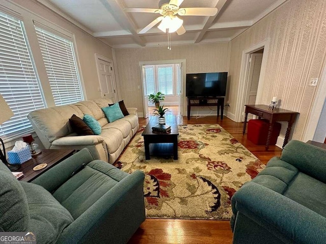 living room with ceiling fan, hardwood / wood-style flooring, coffered ceiling, and beamed ceiling