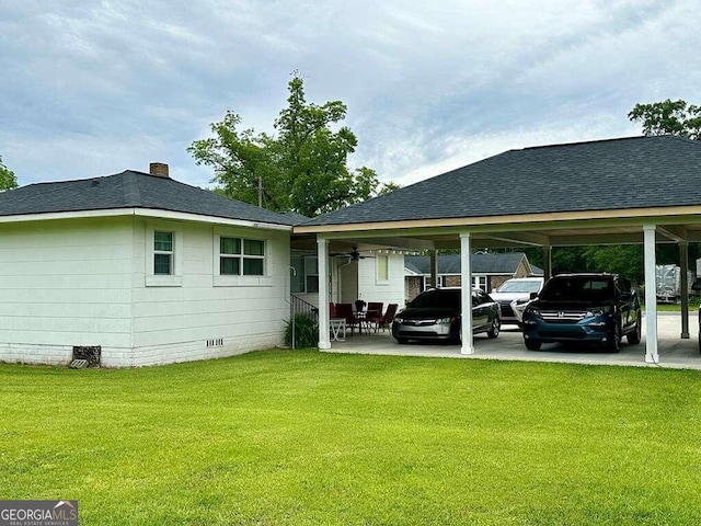 rear view of house with a yard and a carport