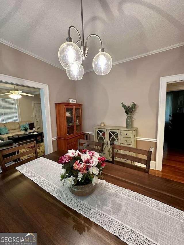 dining room with ceiling fan, crown molding, and wood-type flooring