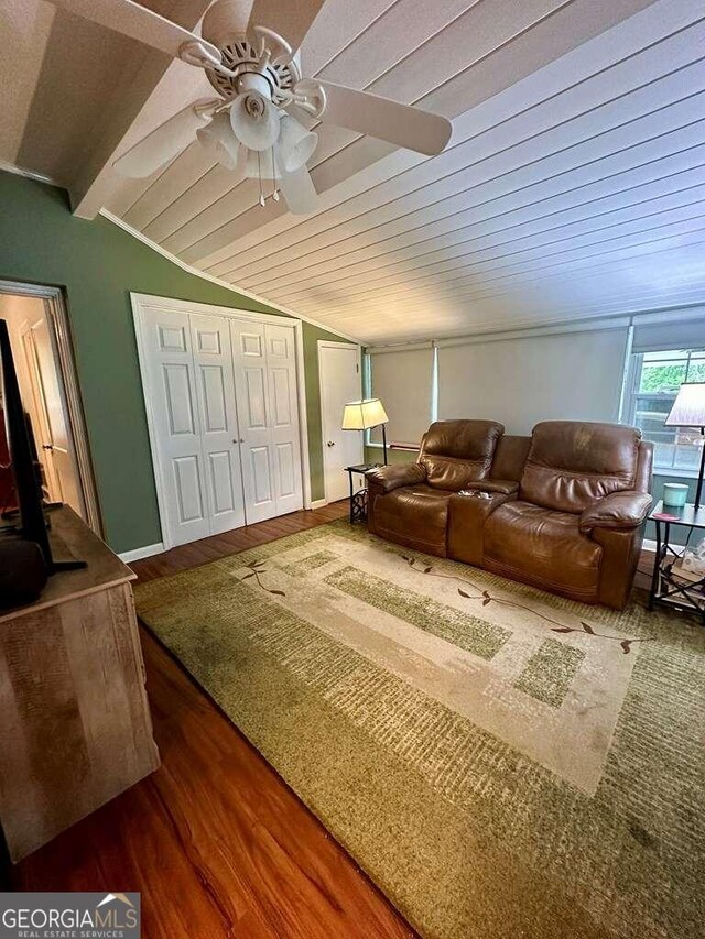 living room with ceiling fan, vaulted ceiling, and hardwood / wood-style floors