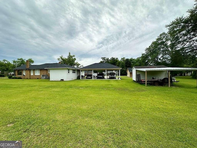 view of yard with an attached carport