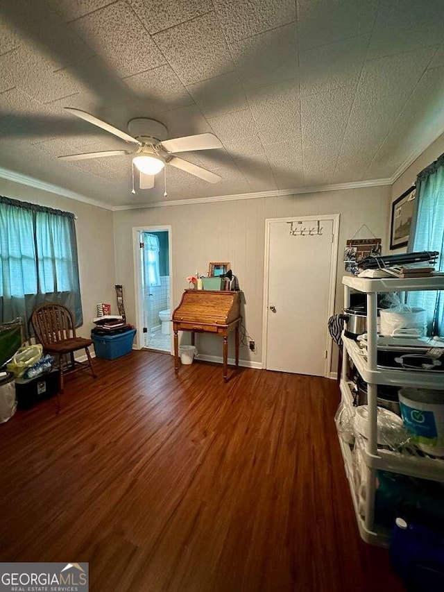 interior space with ornamental molding, wood finished floors, and a ceiling fan