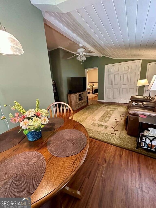 dining area with ceiling fan, vaulted ceiling with beams, and light hardwood / wood-style floors