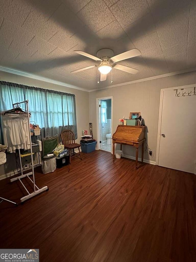 misc room featuring ceiling fan, a textured ceiling, ornamental molding, and wood finished floors