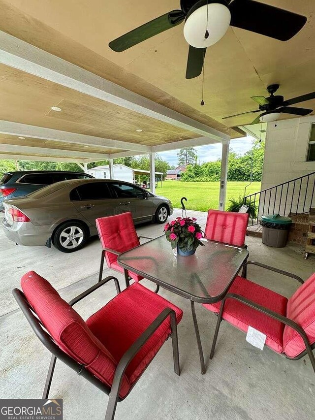 exterior space with ceiling fan and a carport