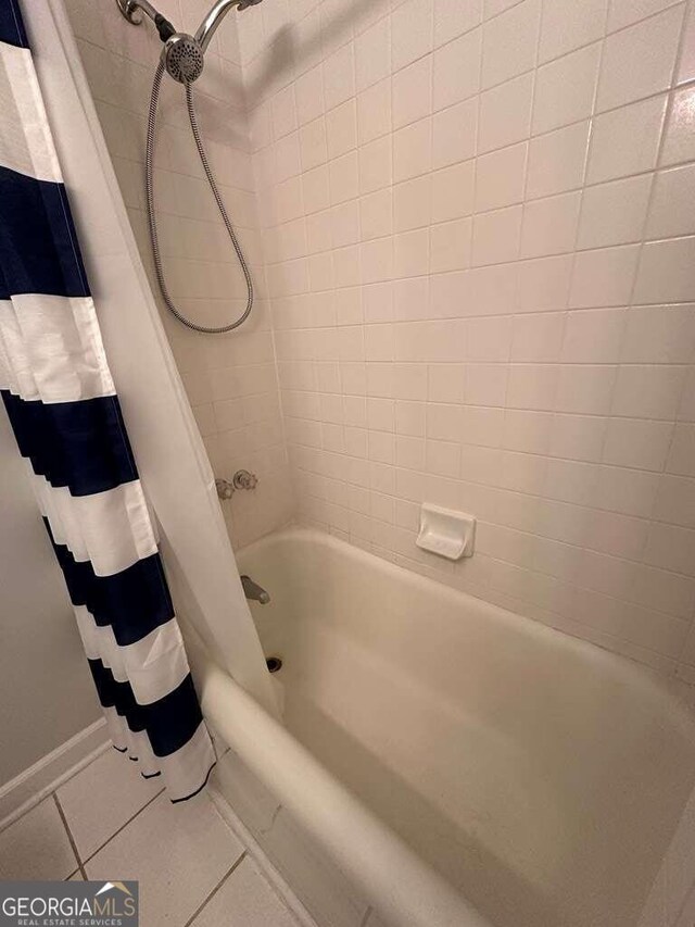 bathroom with shower / bath combination with curtain and tile patterned floors