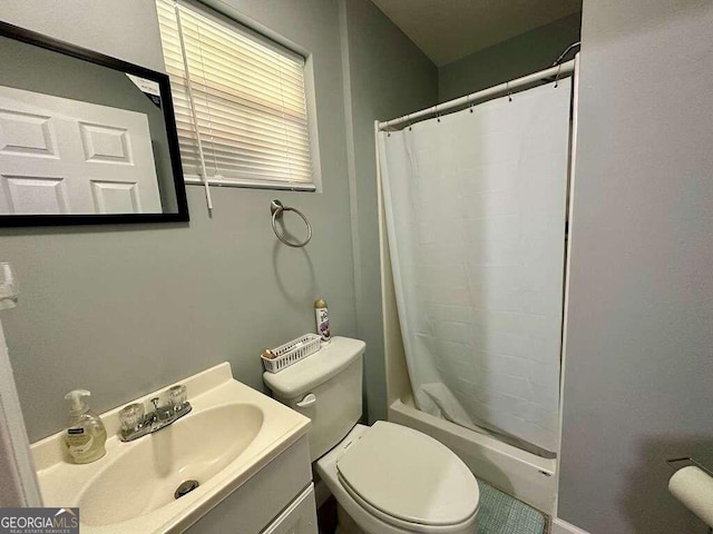 bathroom featuring shower / bathtub combination with curtain, vanity, and toilet