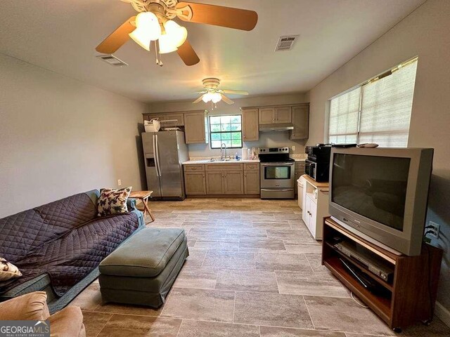 tiled living room with ceiling fan and sink