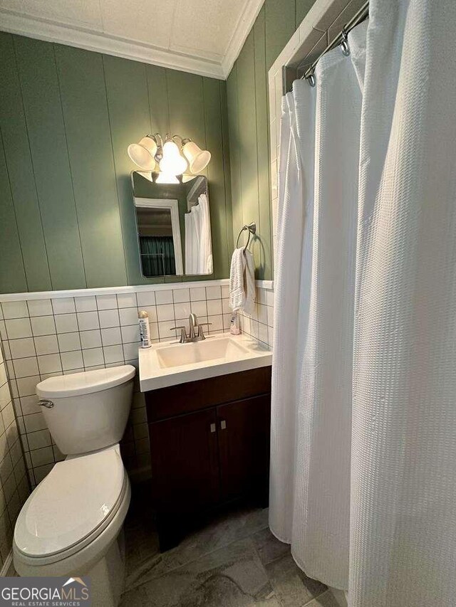 bathroom with decorative backsplash, tile patterned floors, vanity, tile walls, and toilet