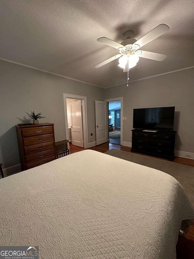 bedroom with ceiling fan and a textured ceiling