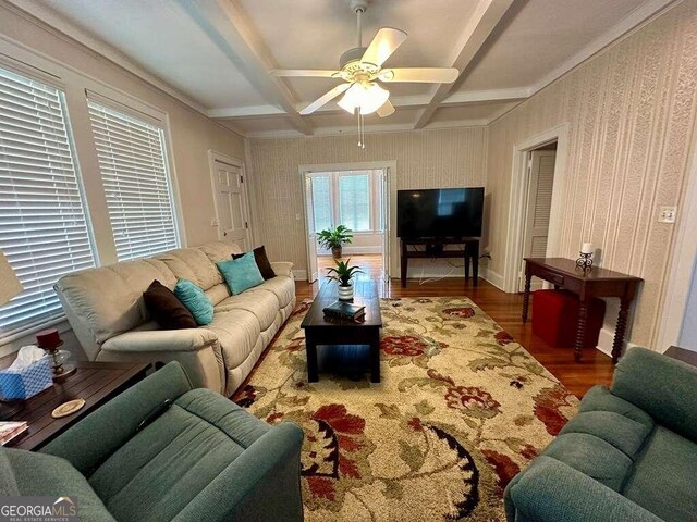 living room with ceiling fan, hardwood / wood-style flooring, coffered ceiling, and beamed ceiling