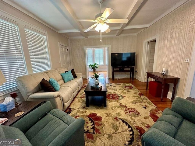 living room featuring wallpapered walls, coffered ceiling, ceiling fan, wood finished floors, and beam ceiling