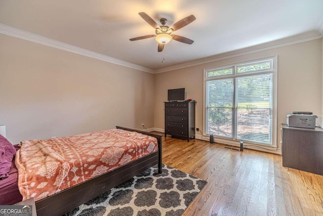 bedroom with light hardwood / wood-style flooring, ceiling fan, and crown molding