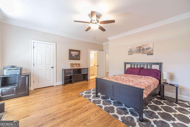 bedroom featuring light wood-type flooring, ornamental molding, ceiling fan, and ensuite bath