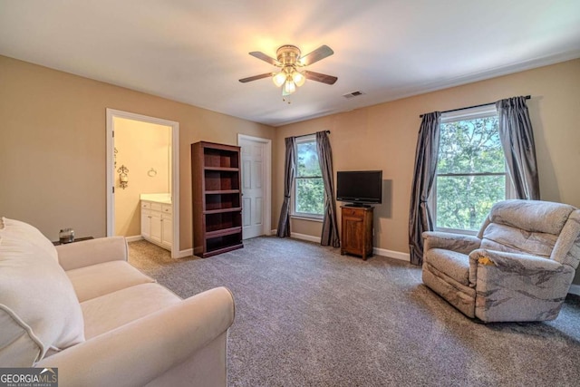 living room with ceiling fan and carpet