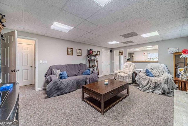 living room with carpet flooring and a drop ceiling