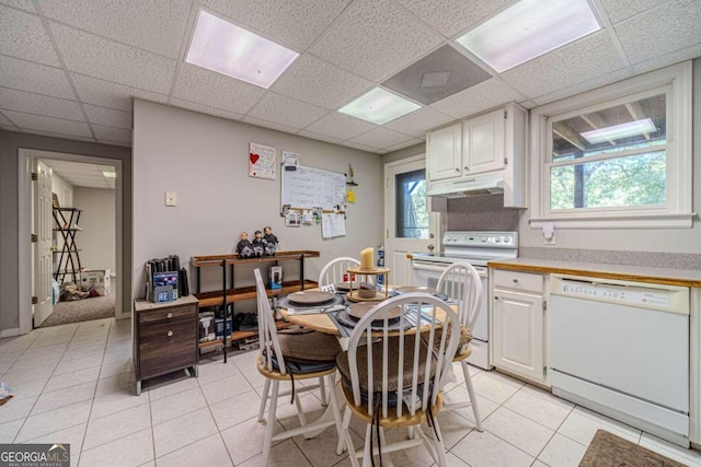 kitchen featuring white appliances, white cabinetry, and plenty of natural light