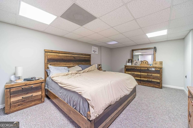 bedroom featuring carpet floors and a paneled ceiling