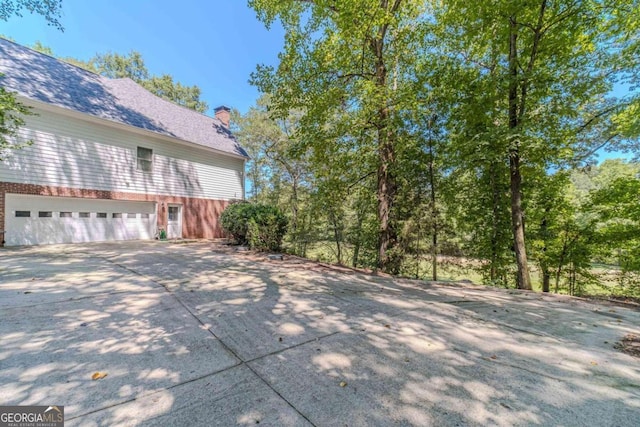 view of property exterior featuring a garage