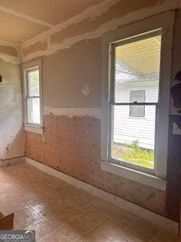 spare room with tile patterned floors